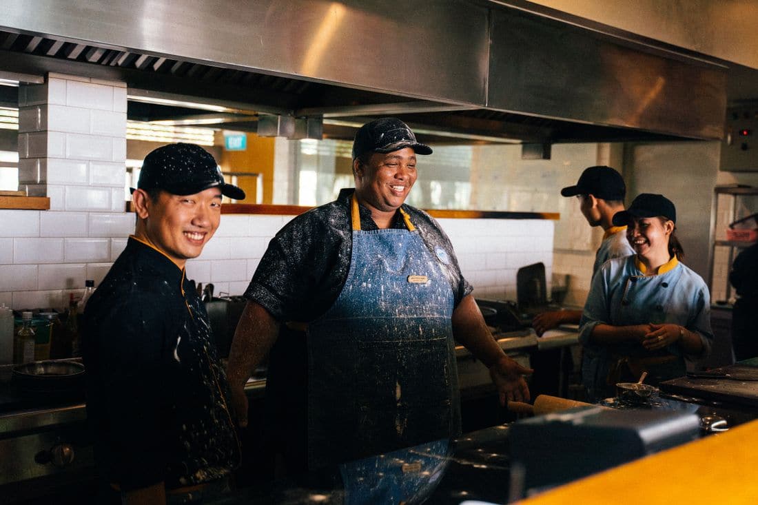 Chefs working together in a busy restaurant kitchen