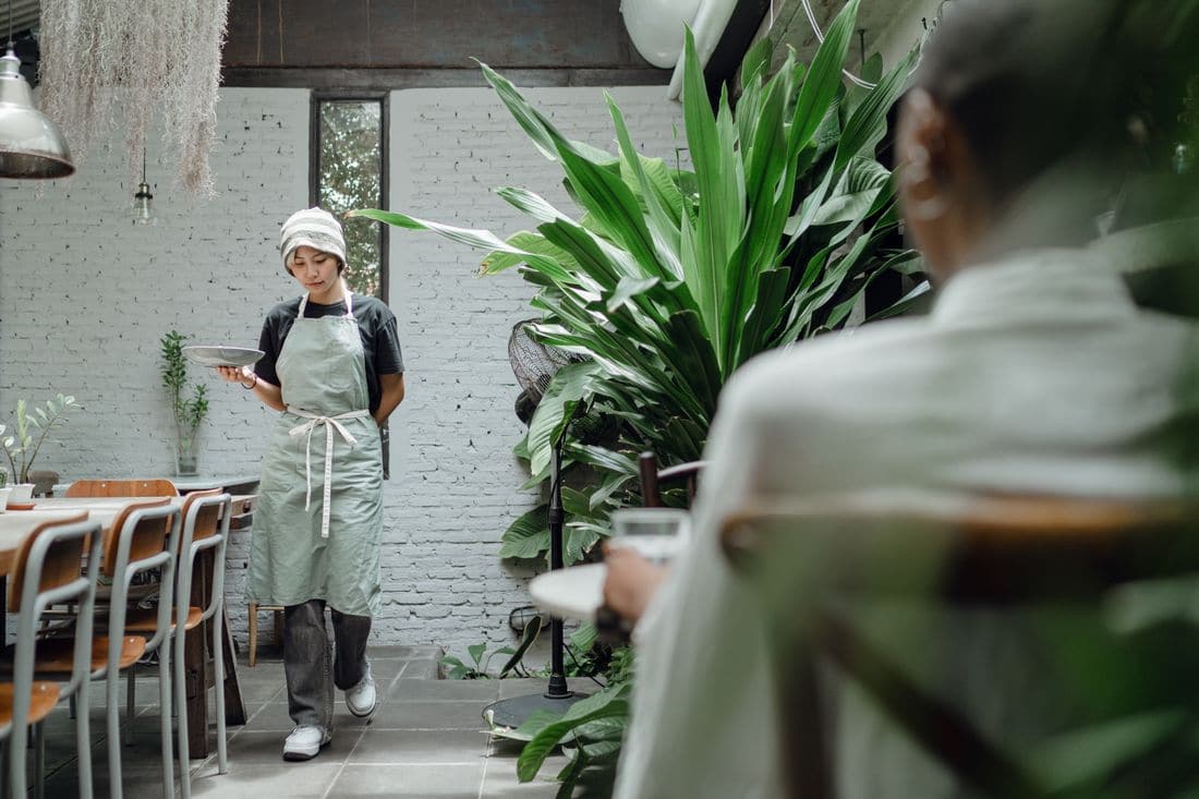A server carrying plates through a restaurant