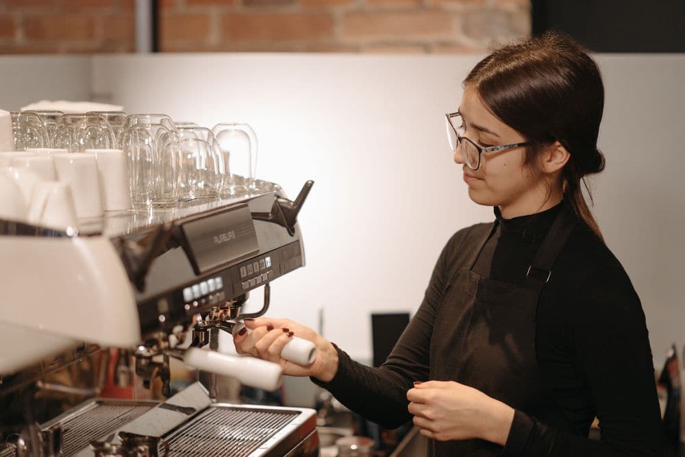 A barista pulling a shot at an espresso machine