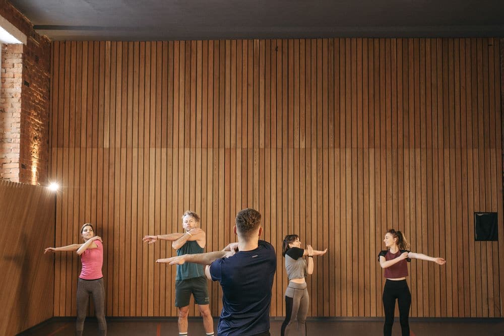 An instructor leading a stretching class