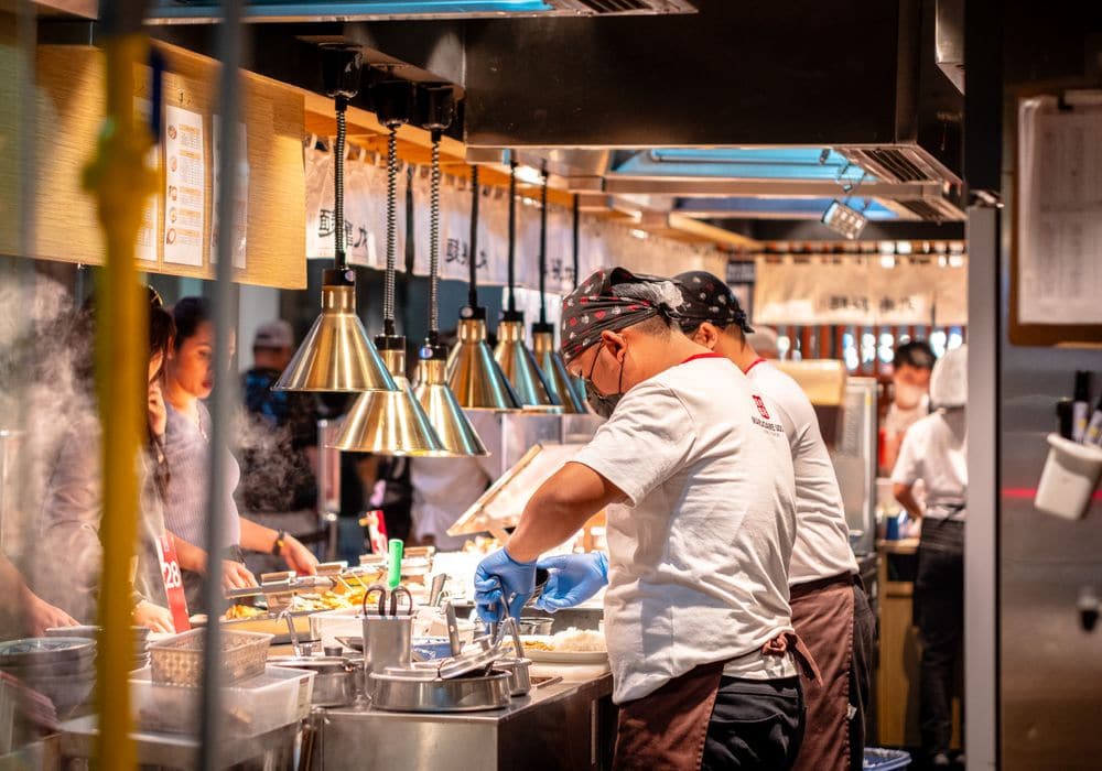 Kitchen staff working together through a service